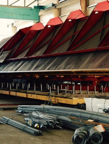 Stacks of steel reinforcement bars in ARGE Baustahl’s warehouse, illustrating how automated steel-list generation and Workflow Intelligence improved accuracy and pre-production efficiency.