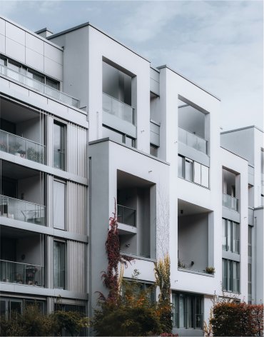 Modern residential building with clean architectural lines and balconies, representing high-quality real estate assets relevant for Berlin Hyp’s digital portfolio management.