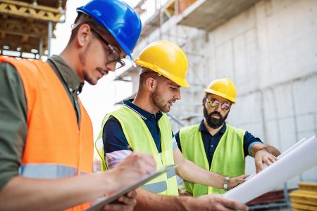 Construction team reviewing plans on site, illustrating digital workflow coordination from the construction management case study.
