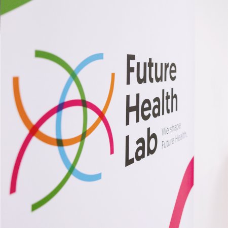 Future Health Lab signage, representing the innovation center focused on transforming healthcare through a collaboration with sclable and other partners, aimed at improving patient care and healthcare systems with human-centered solutions.