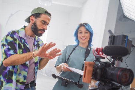 Film professionals coordinating a video production setup, representing digital workflows and collaboration for the Vienna Film Commission.