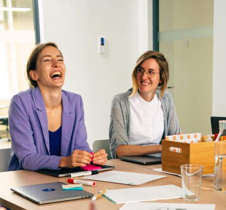 Two UX designers sitting at a meeting table